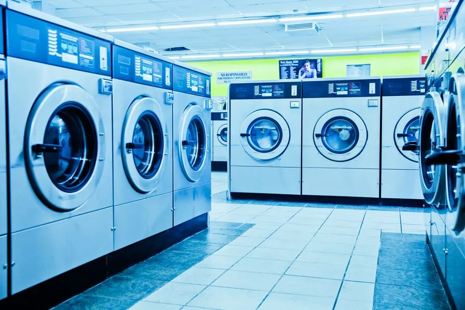 Bright and contemporary laundromat with rows of washing machines.